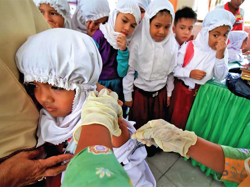 Murid-murid perempuan di sebuah sekolah dasar menjalani imunisasi HPV, beberapa waktu lalu. Imunisasi HPV bermanfaat mencegah kanker serviks.