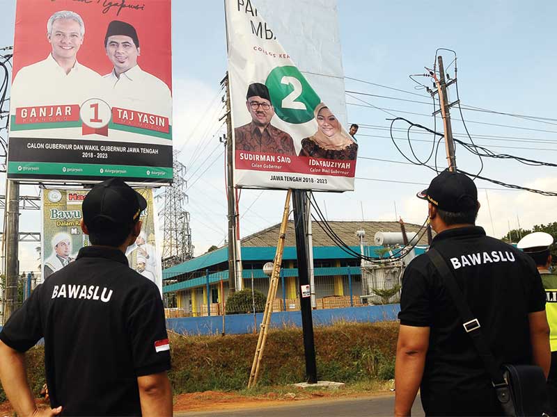 Petugas menurunkan alat peraga kampanye (APK) peserta pilgub Jateng di Jepara, Jawa Tengah, Minggu (24/6/2018)