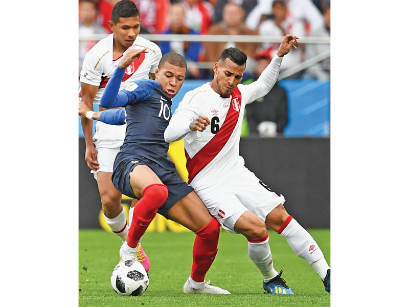 Pemain depan Prancis Kylian Mbappe (tengah) berebut bola dengan bek Peru Miguel Trauco (kanan) dalam pertandingan sepak bola Grup C Piala Dunia 2018 antara Prancis dan Peru di Ekaterinburg Arena, kemarin. Timnas Prancis memastikan tiket ke babak 16 besar P