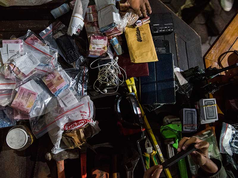 Petugas lapas menata uang dan barang-barang sitaan hasil sidak di Lapas Sukamiskin, Bandung, Jawa Barat, Minggu (22/7/2018).