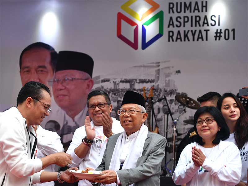Cawapres nomor urut 01 Ma'ruf Amin (tengah) menerima nasi tumpeng dari Kepala Kantor Rumah Aspirasi Rakyat #01 Deddy Yevri Sitorus (kiri) disaksikan Sekretaris Tim Kampanye Nasional Hasto Kristiyanto (kedua kiri) saat peluncuran rumah tersebut di Menteng, 