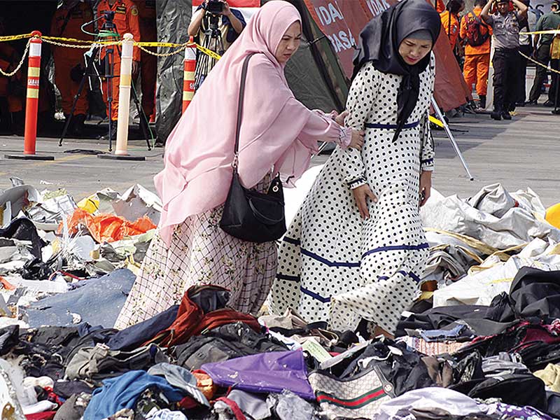 MENCARI BARANG MILIK SUAMI: Dian Anindita (kanan), istri AKB Mito, korban jatuhnya pesawat Lion Air Boeing 737-8 Max nomor penerbangan JT610, dengan ditemani keluarga mencari barang milik suaminya di Posko Evakuasi JICT 2 Pelabuhan Tanjung Priok, Jakarta, 