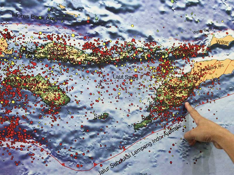 Seorang petugas Badan Meteorologi, Klimatologi dan Geofisika (BMKG) Stasiun Geofisika Klas I Kupang menunjukkan peta sebaran pusat gempa wilayah Nusa Tenggara Timur (tanda merah) di Kupang, NTT, Senin (15/2). 