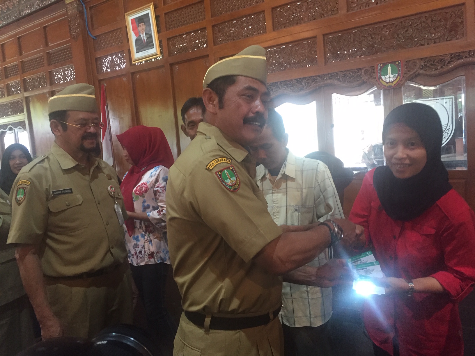 Wali Kota Surakarta, FX. Hadi Rudyatmo didampingi Wakil Wali Kota, Achmad Purnomo secara simbolis menyerahkan kartu JKN-KIS kepada perwakilan warga penerima manfaat di Pendapi Gede, Balai Kota setempat, Senin. (21/1).