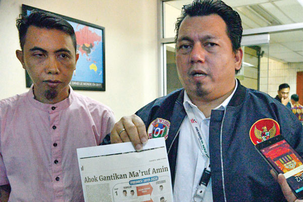 Direktur Hukum dan Advokasi TKN Jokowi-Ma’ruf, Ade Irfan Pulungan (kanan), memberikan keterangan seusai melaporkan Harian Indopos terkait pemberitaan pada edisi Rabu (13/2) yang berjudul Ahok Gantikan Ma’ruf Amin? di Gedung Dewan Pers, Jakarta, Jumat (15/2