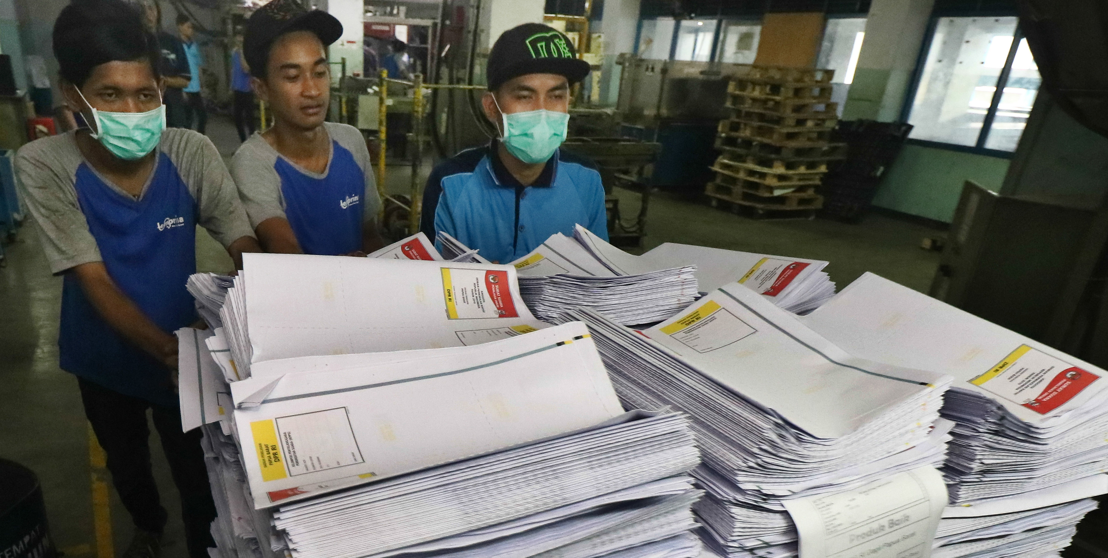 Pekerja membawa hasil cetak surat suara Pemilu 2019 untuk dilakukan proses pemotongan di PT Temprina Media Grafika Jalan Raya Sumengko Km 30