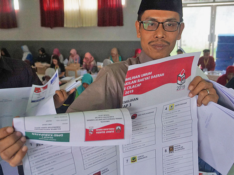 Petugas Komisi Pemilihan Umum (KPU) memperlihatkan surat suara rusak yang ditemukan saat penyortiran di kantor KPU.