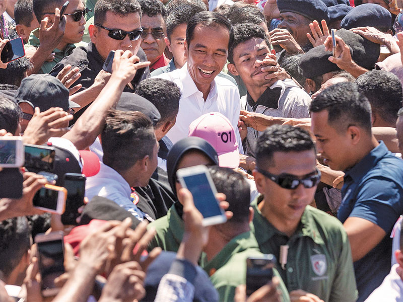 Calon presiden nomor urut 01 Joko Widodo menyapa para pendukung yang mendekatinya saat kampanye terbuka di Lapangan Sitarda Lasiana, Kupang.