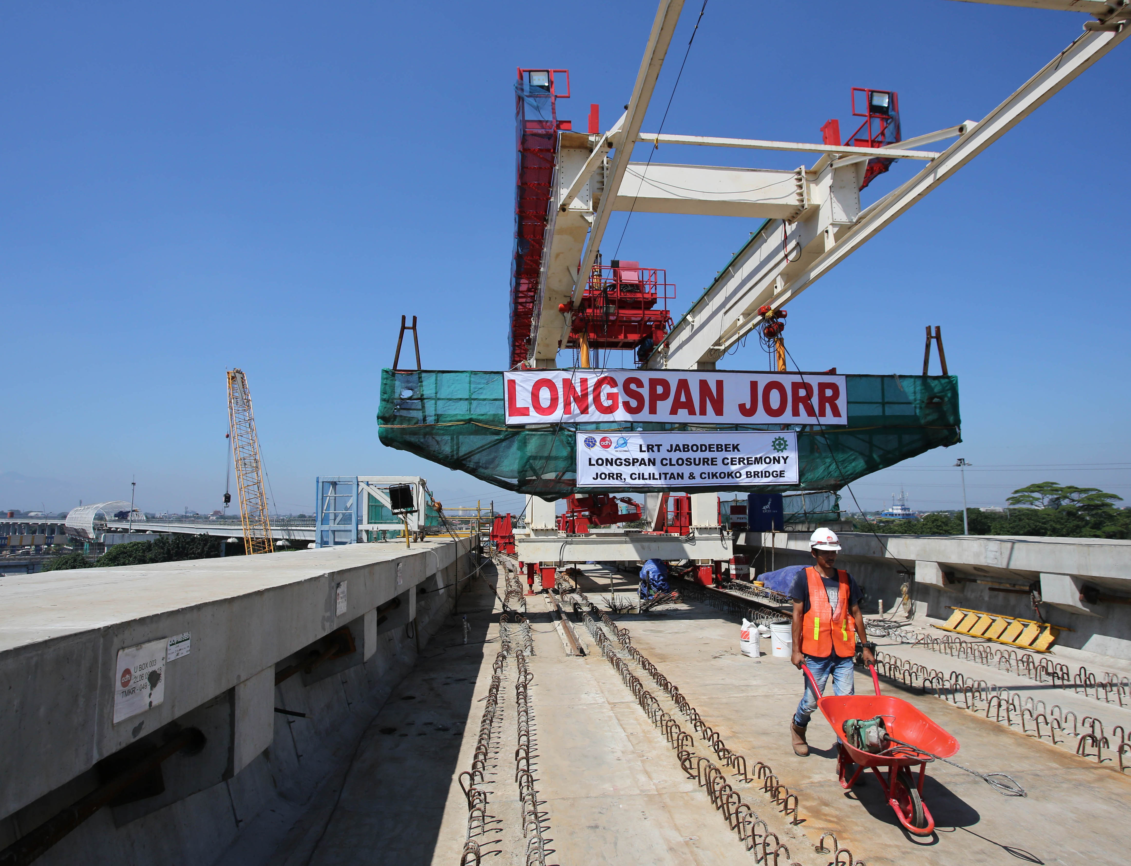  Pekerja menyelesaikan proyek pembangunan LRT yang membelah Tol Jagorawi dan JORR di kawasan Cililitan, Jakarta Timur, Jumat (29/3).