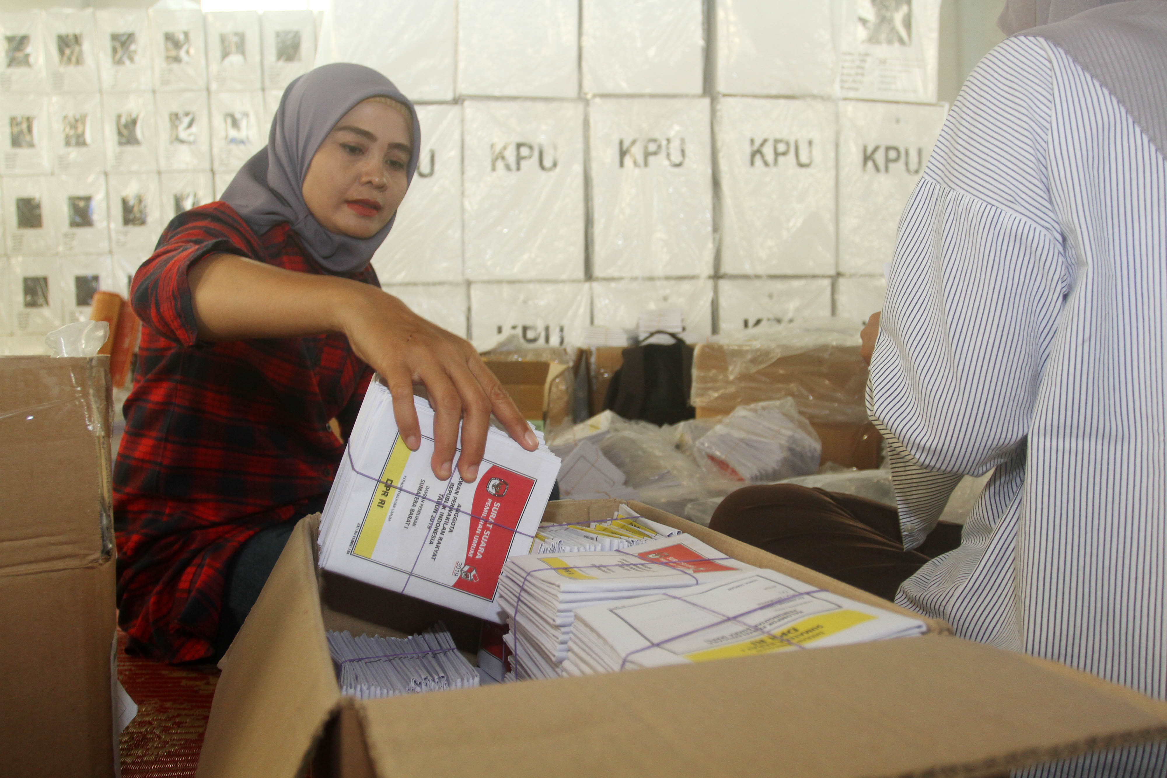 Anggota PPK Padang Barat memasukkan surat suara ke dalam kardus sebelum distribusikan ke TPS di Padang.