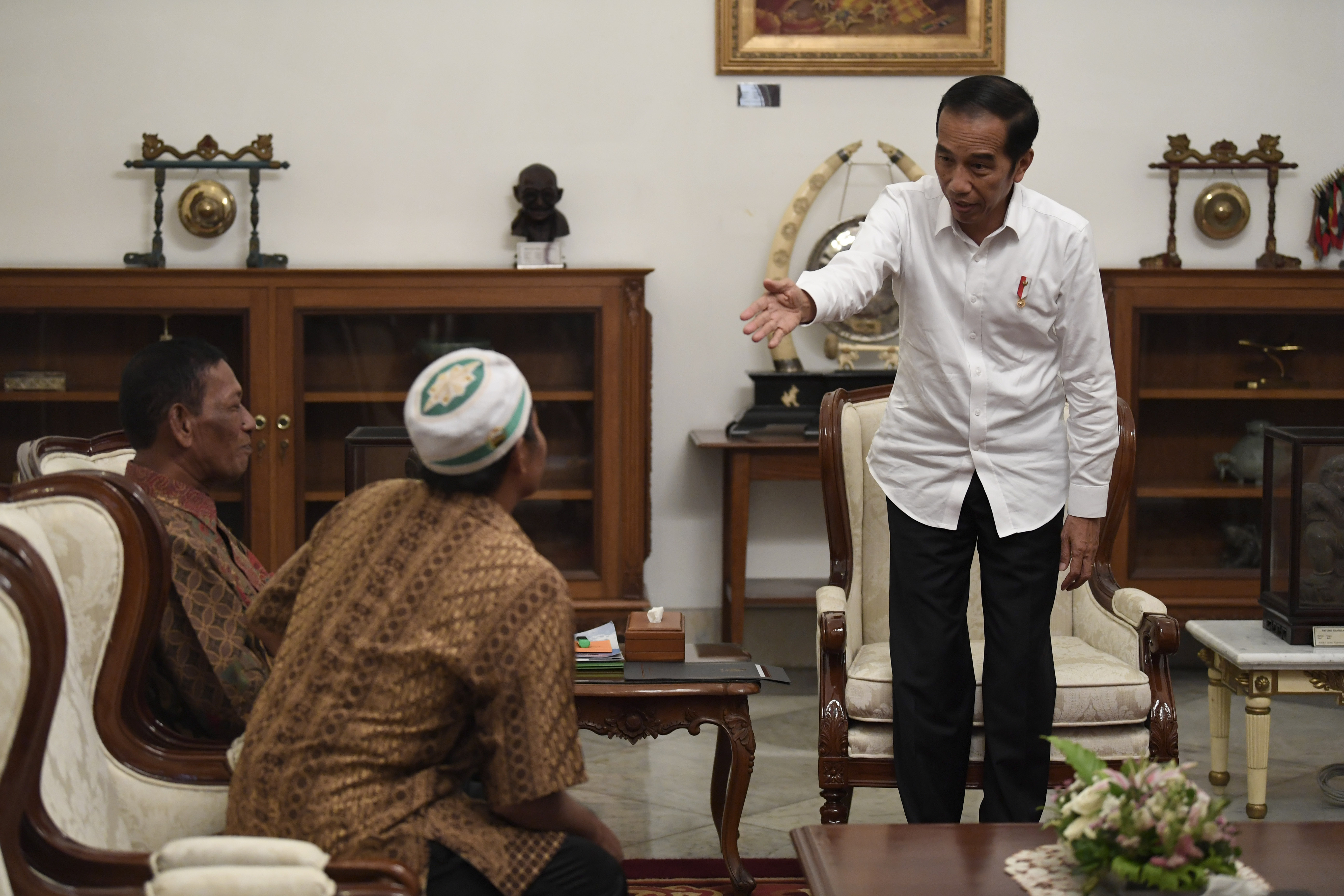 Presiden Joko Widodo (kanan) menerima pedagang kaki lima yang menjadi korban penjarahan saat aksi 22 Mei, Abdul dan Ismail, Jumat (24/5).