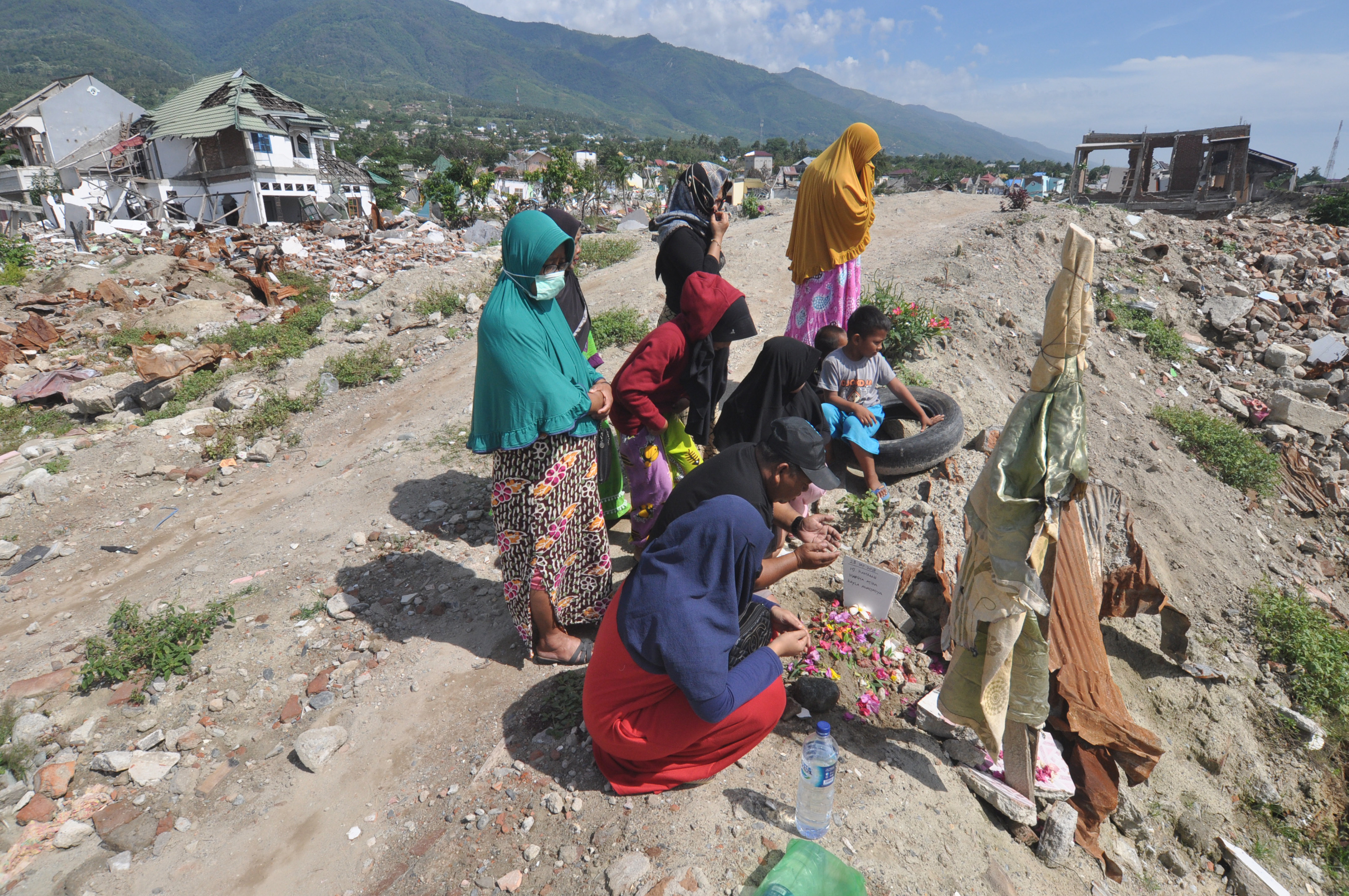 Warga berziarah di lokasi tempat hilangnya anggota keluarga mereka yang terdampak bencana likuifaksi di Balaroa, Palu, Sulawesi Tengah.