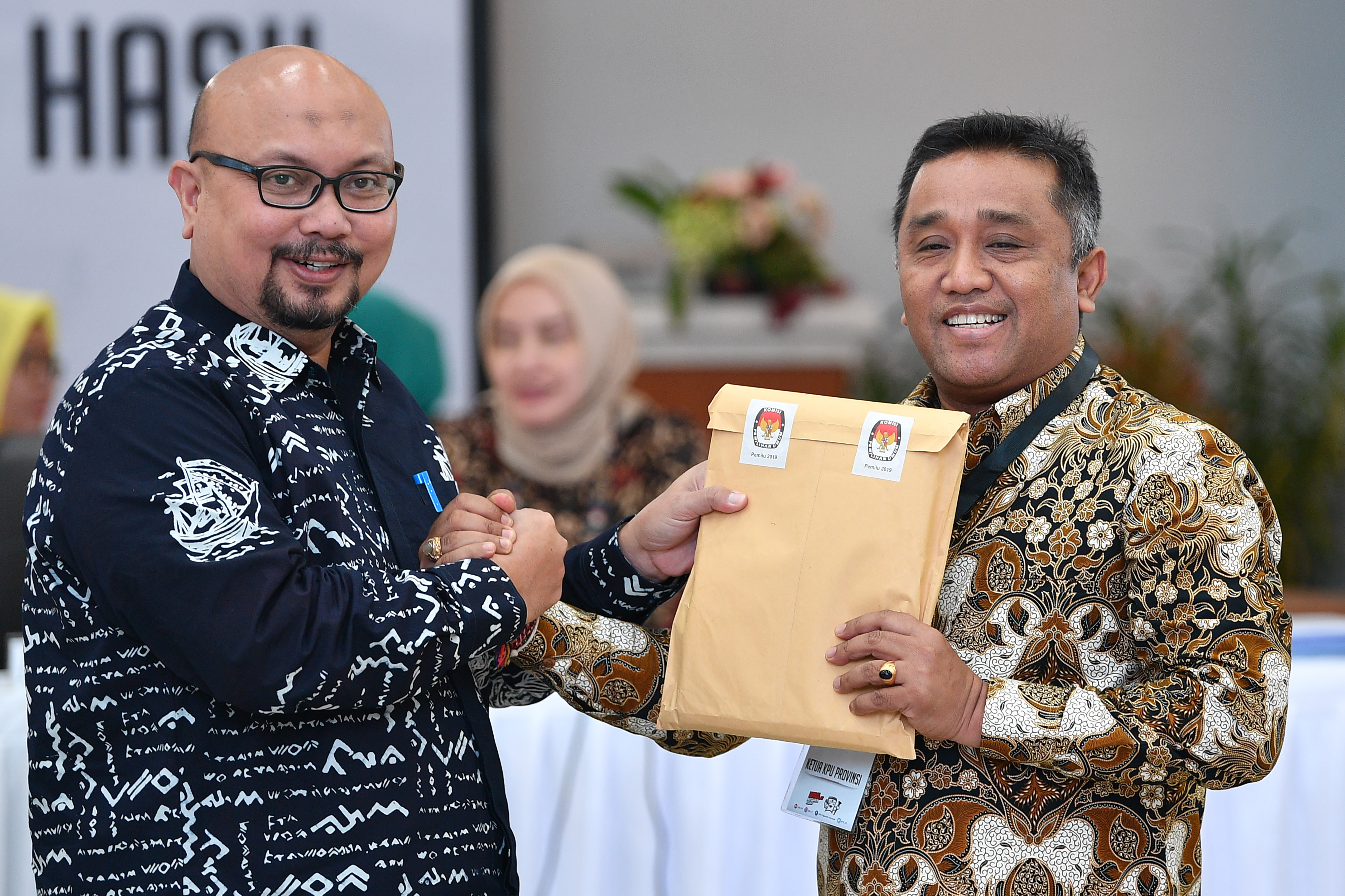 Komisioner KPU Ilham Saputra (kiri) berjabat tangan dengan Ketua KPU Bali I Dewa Agung Gede Lidartawan.