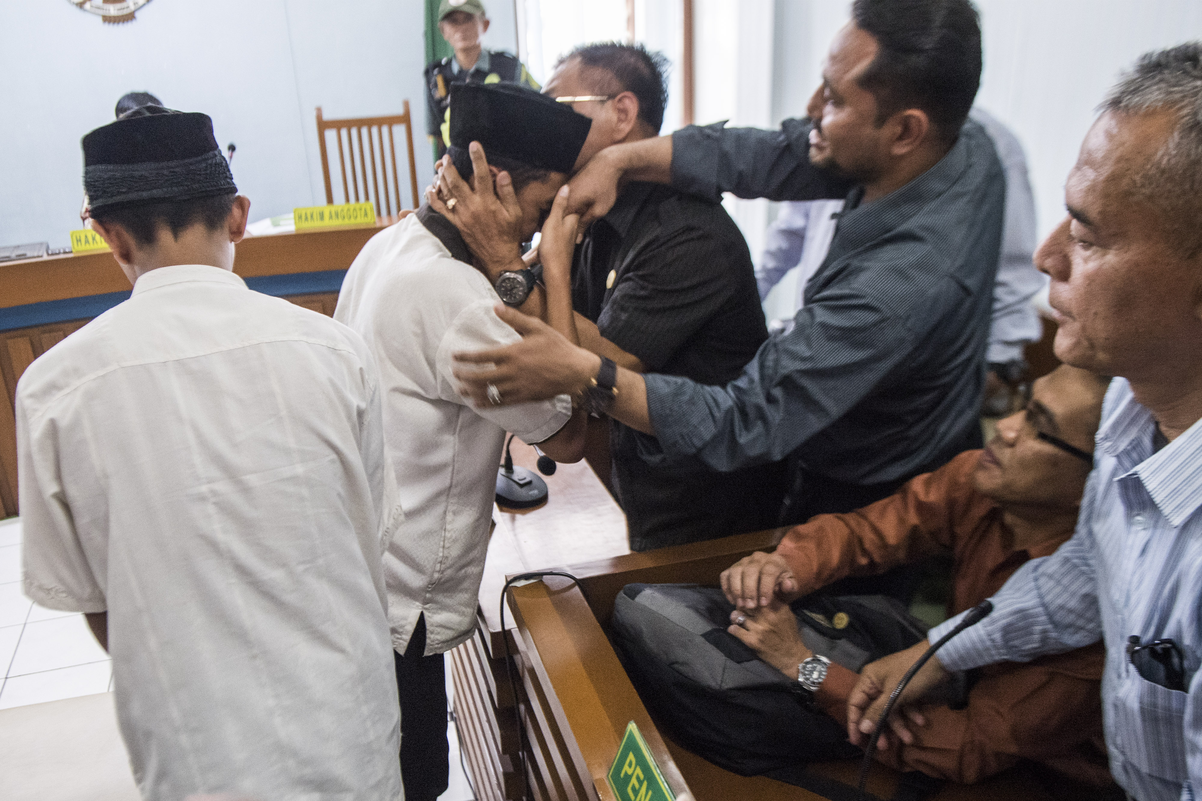 Dua terdakwa pengeroyokan Haringga Sirla yang berinisial AP (kiri) dan NSF (kedua kiri) memeluk pendamping seusai mengikuti sidang