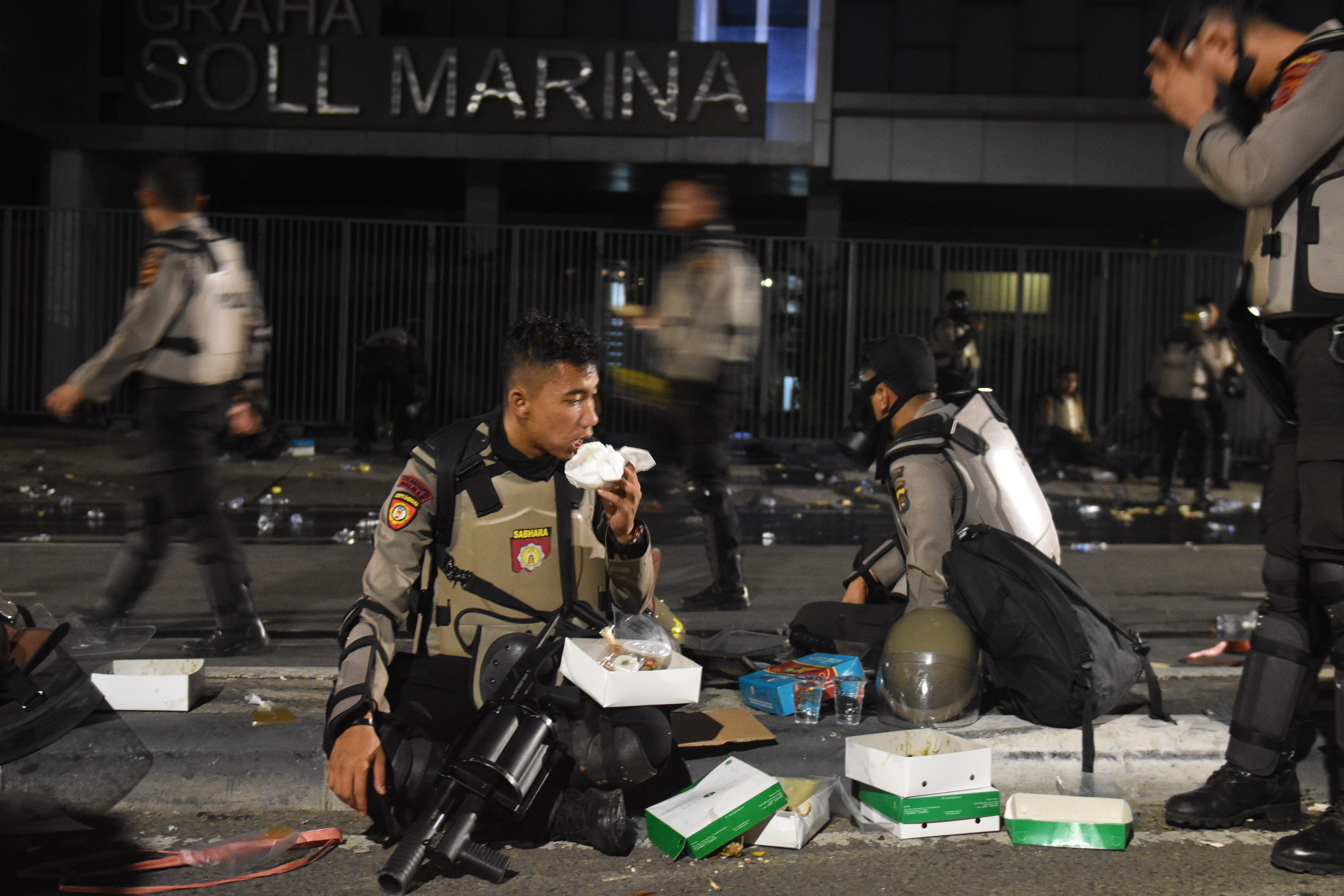 Polisi yang mengamankan aksi demonstrasi di depan Bawaslu berbuka puasa