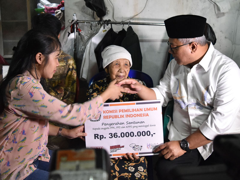 Ketua KPU Arief Budiman (kanan) menyerahkan santunan kepada keluarga almarhum Tutung Suryadi, petugas KPPS yang wafat, di Tangki, Tamansari