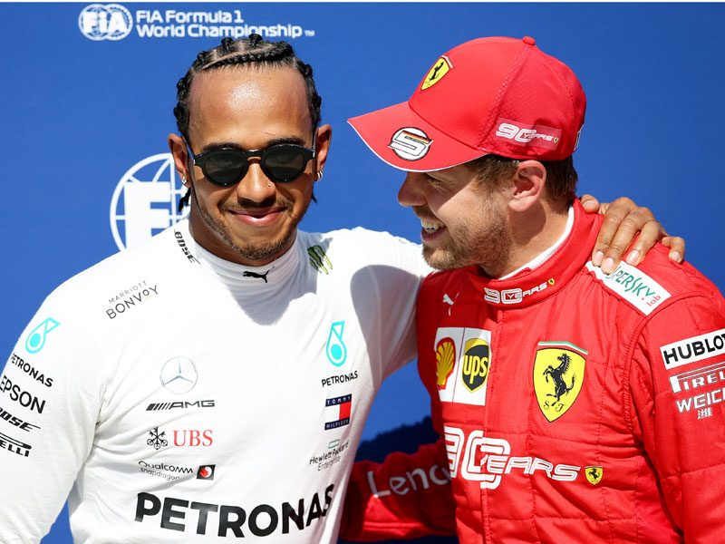 Lewis Hamilton (kiri) dan Sebastian Vettel (kanan).