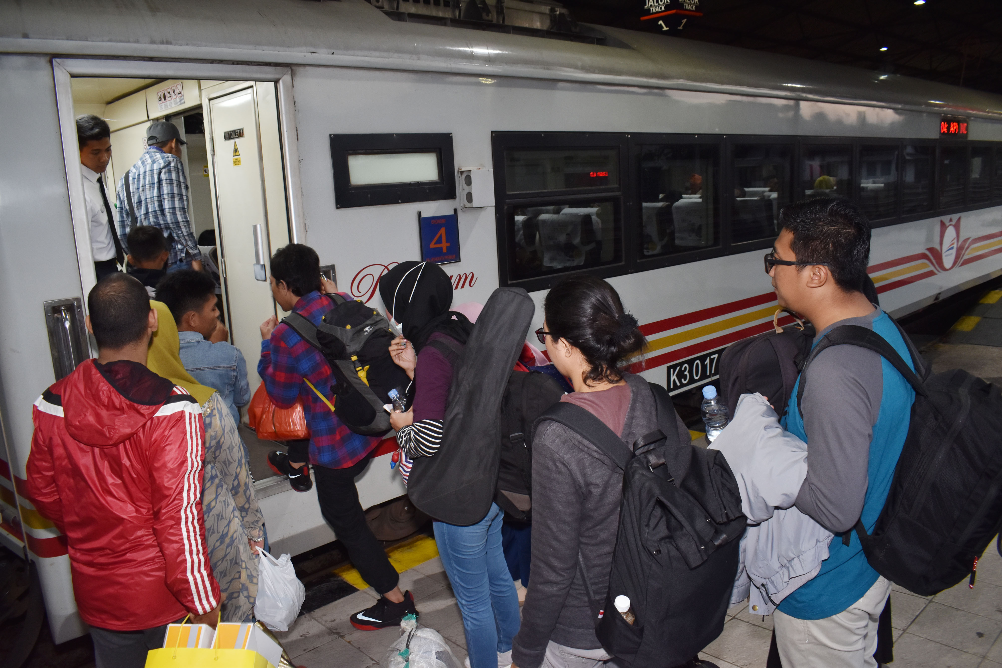 Sejumlah calon penumpang bersiap naik Kereta Api (KA) di Stasiun (KA) Madiun, Jawa Timur.