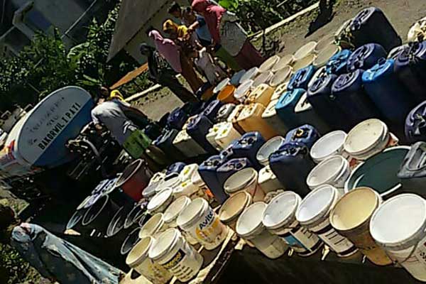 Warga antri untuk mendapatkan air bersih.