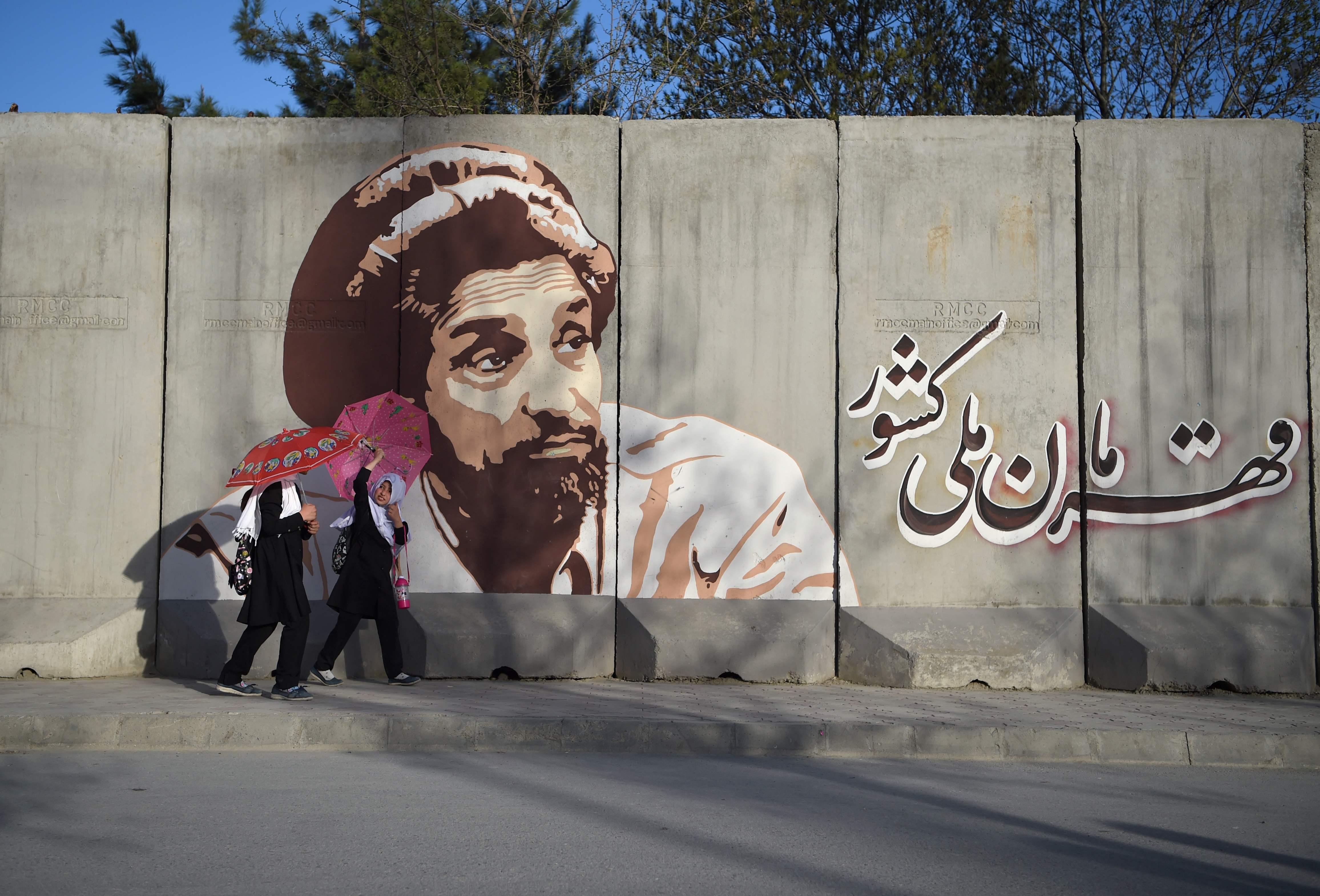 Dua orang perempuan tampak sedang berjalan di salah satu sudut kota di Afganistas.