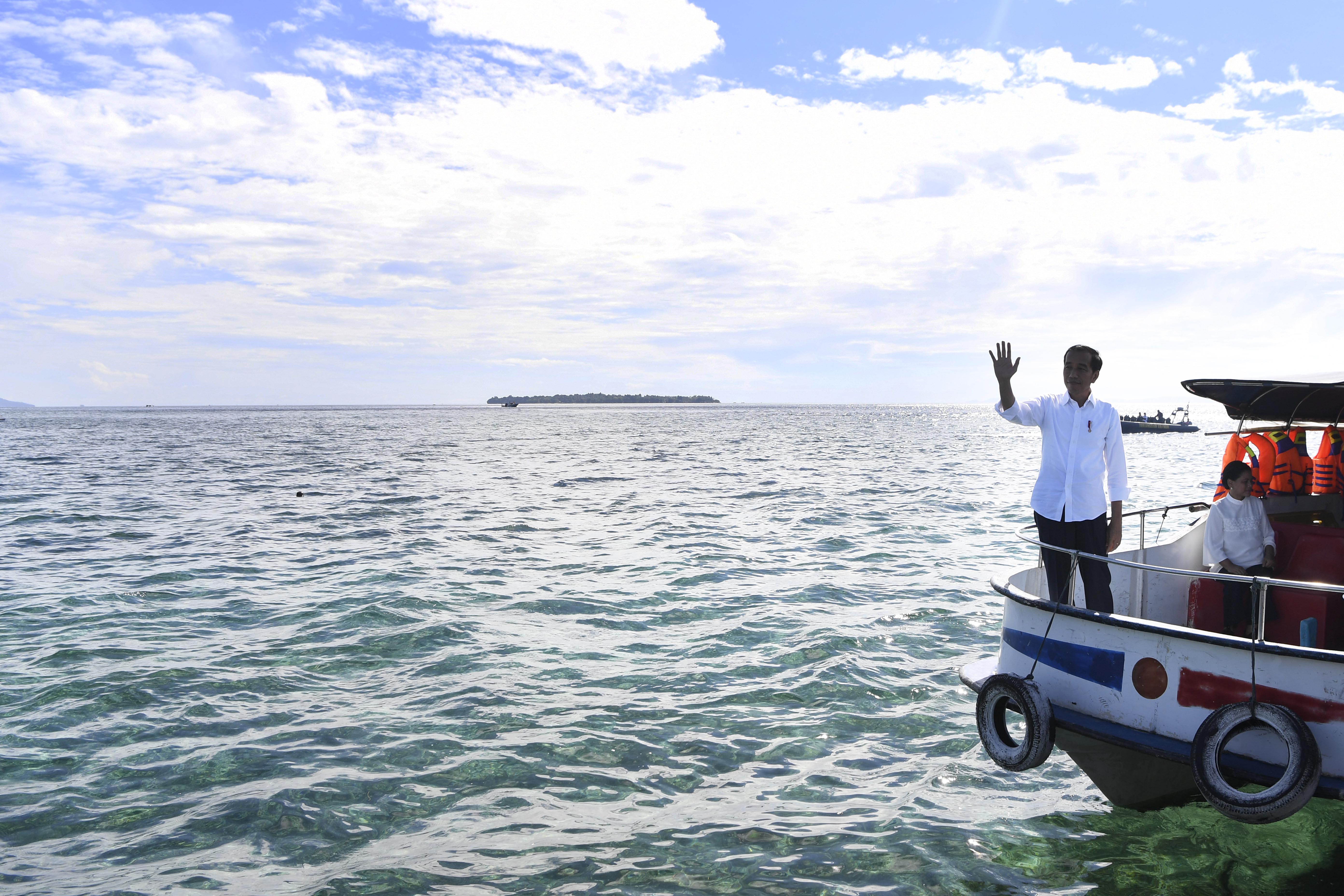 Presiden Joko Widodo (kiri) didampingi Ibu Negara Iriana Joko Widodo mengunjungi kawasan wisata Bunaken di Sulawesi Utara, Jumat (5/7/2019).