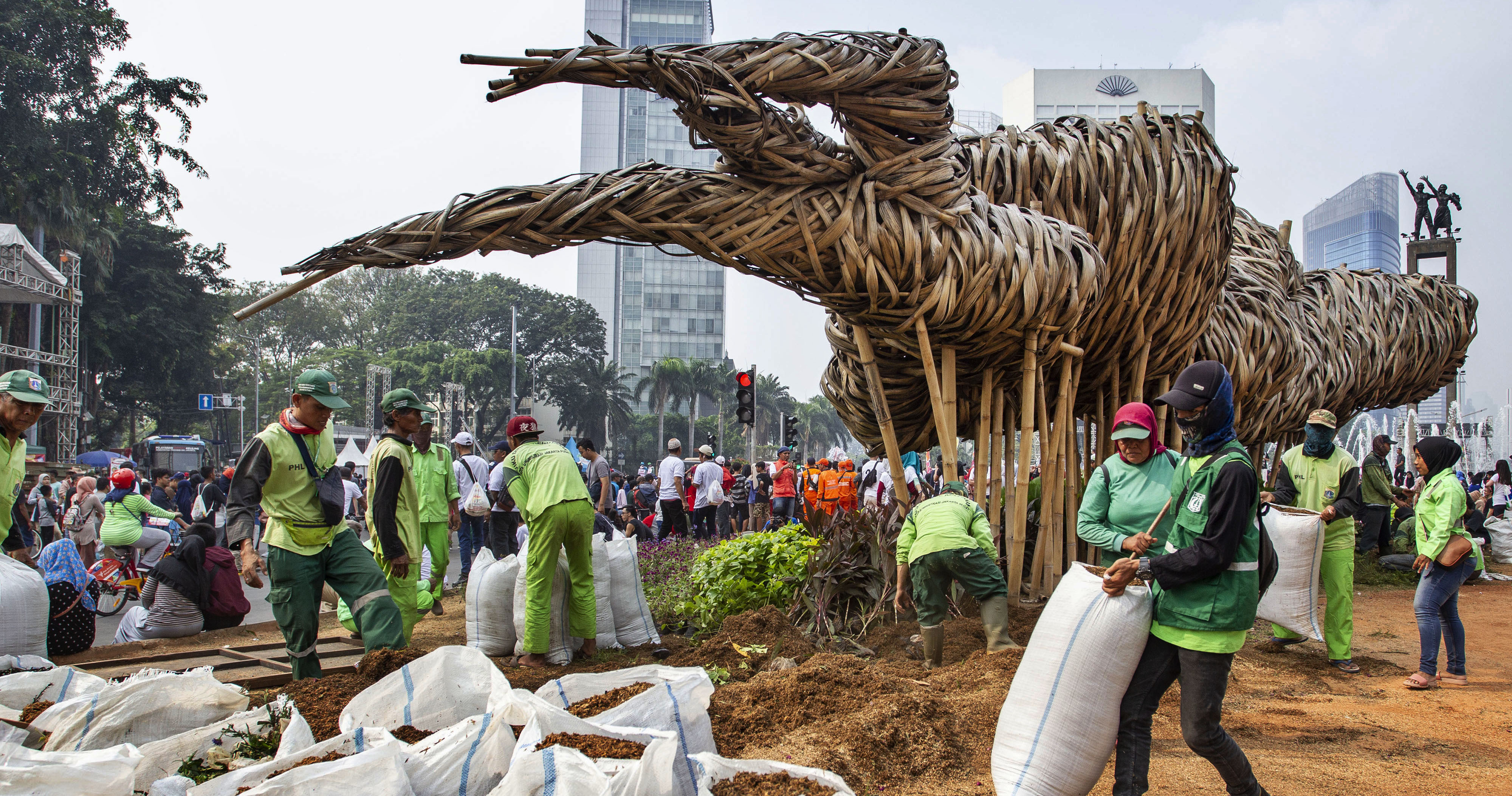Petugas Suku Dinas Kehutanan Jakarta Pusat mengganti tanaman yang rusak di sekitar instalasi bambu Getah Getih, Jakarta, Minggu (23/6)