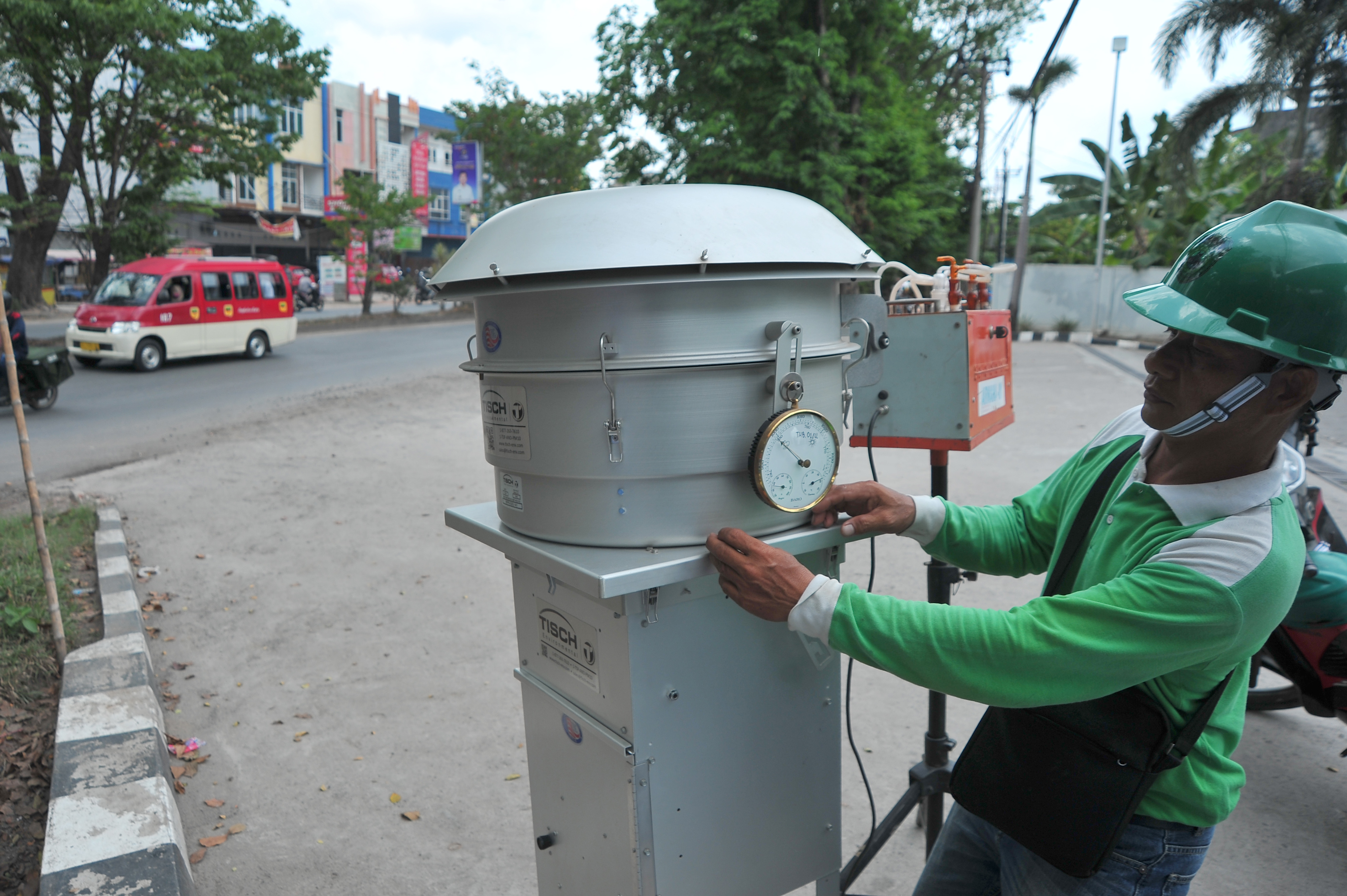 Petugas Badan Lingkungan Hidup memeriksa alat pengukur kualitas udara di salah satu titik jalanan Kota Palembang, Sumatra Selatan