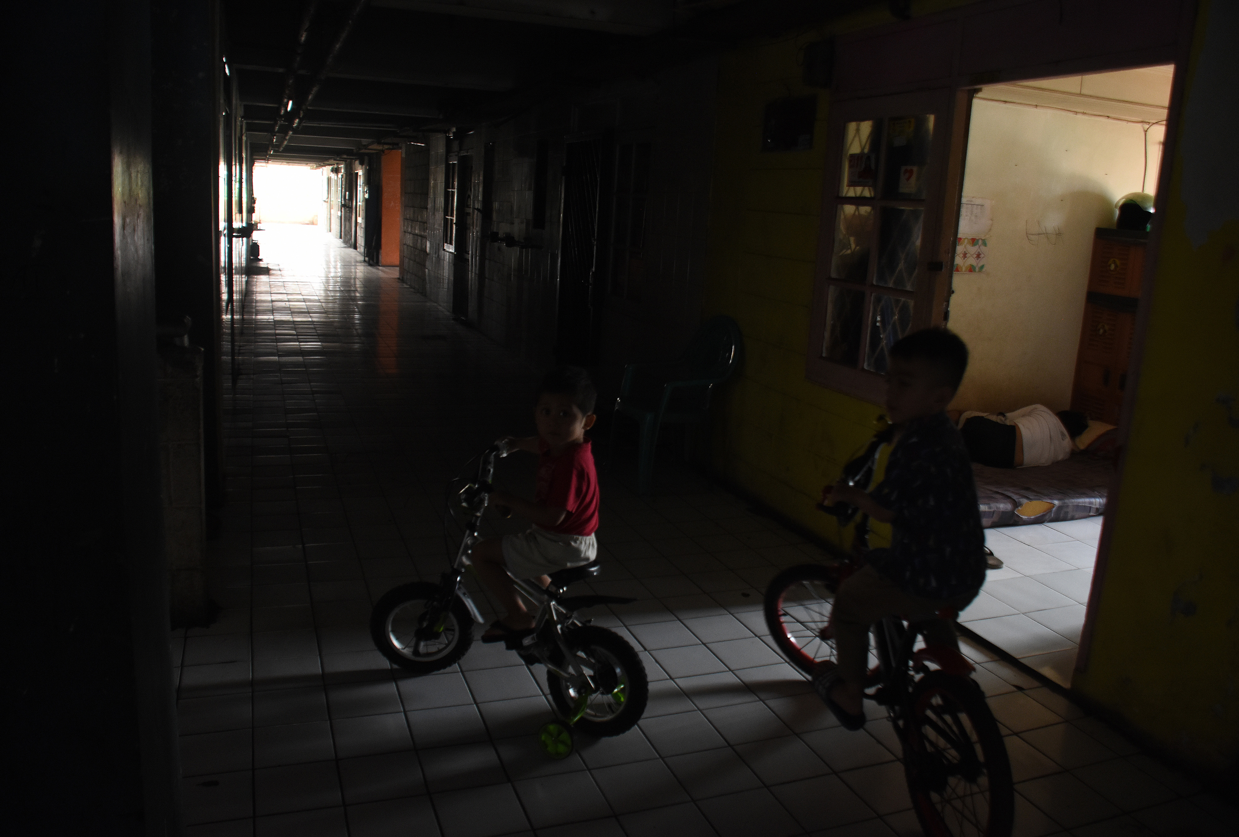Dua anak bermain di Rusun Bendungan Hilir saat terjadi pemadaman listrik bergilir di Jakarta, Senin (5/8)