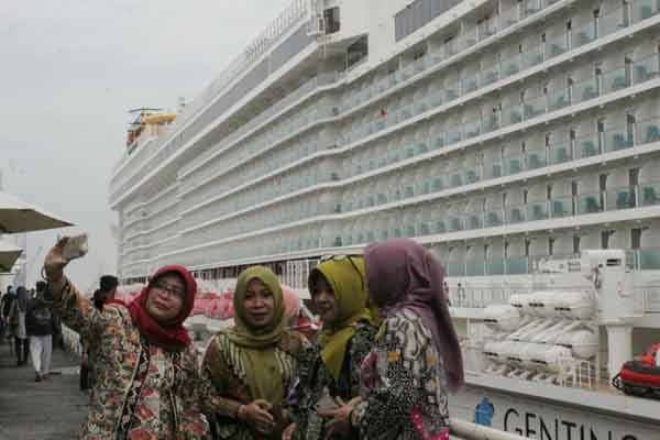 Warga Surabaya berfoto selfie dengan latar belakang kapal pesiar mewah Genting Dream dari Dream Cruises.