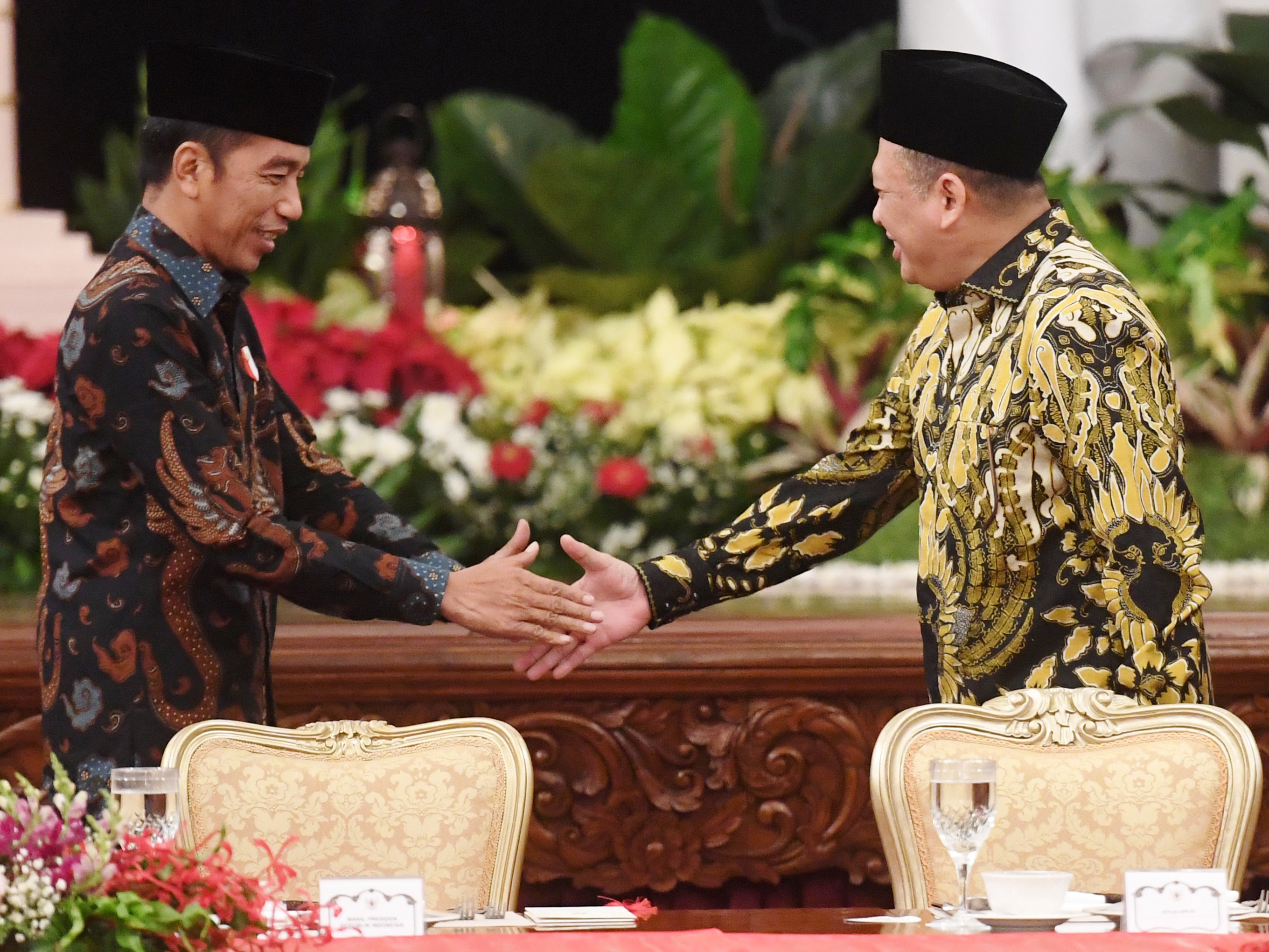 residen Joko Widodo (kiri) berjabat tangan dengan Ketua DPR Bambang Soesatyo