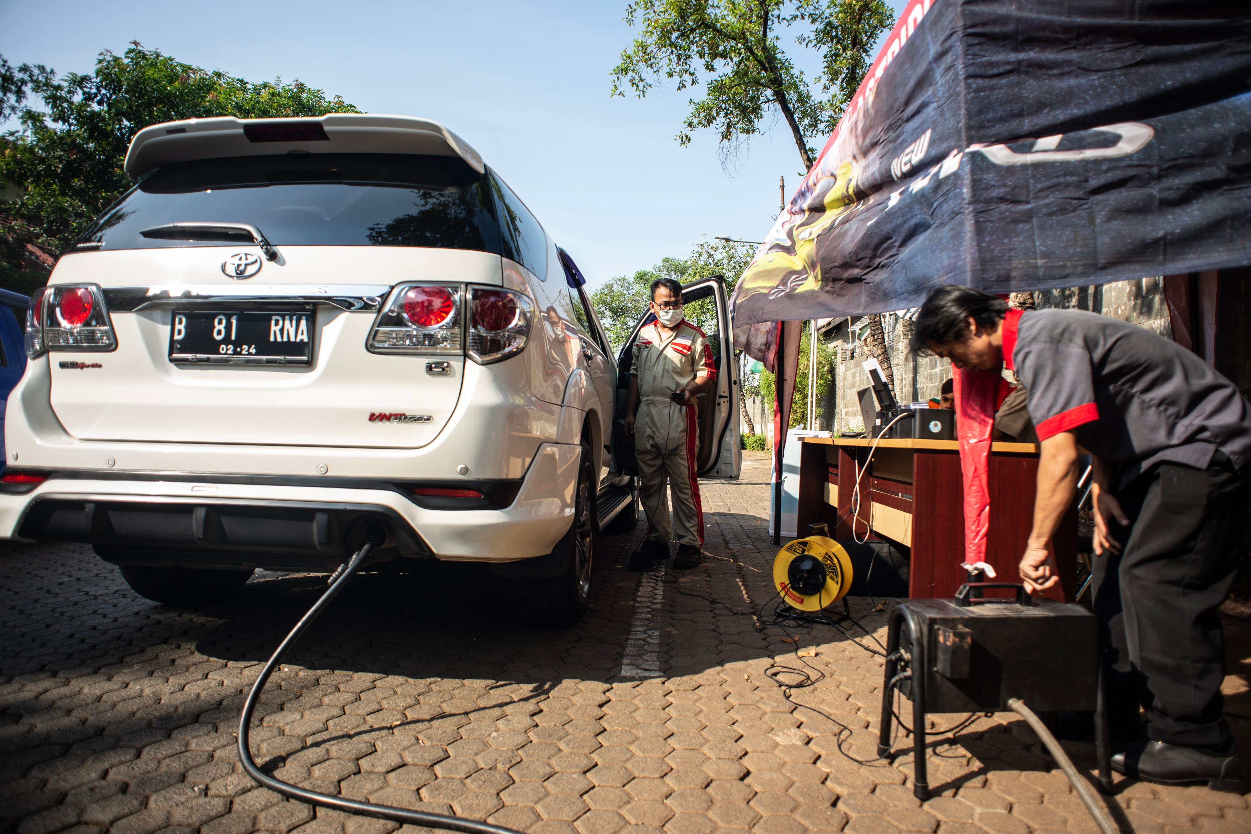 Petugas Sudin Lingkungan Hidup Jakarta Utara melakukan uji emisi kendaraan bermotor di kawasan kantor Wali Kota Jakarta Utara.