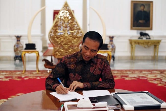 Presiden Joko Widodo saat menulis surat untuk pembaca seusai diwawancarai Media Indonesia di Istana Merdeka, Jakarta, Jumat (16/10/2015).