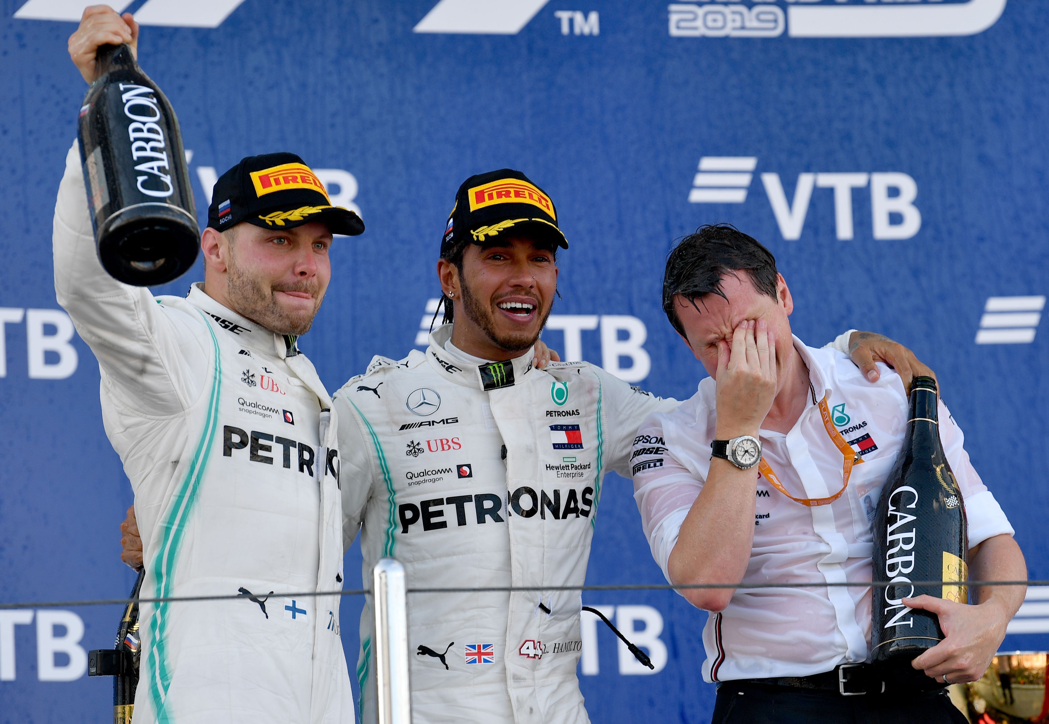 Pembalap Mercedes Valterri Bottas, Lewis Hamilton, dan chief engineer Fred Judd merayakan kemenangan mereka di GP Rusia