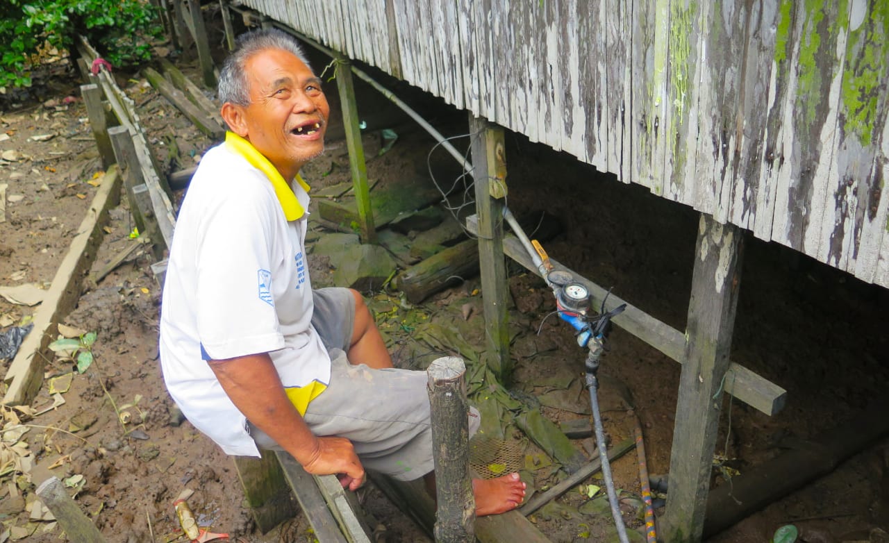 Seorang warga Pulau Laut, Kotabaru, Kalsel, harus menanti giliran pasokan air bersih dari PDAM setempat.
