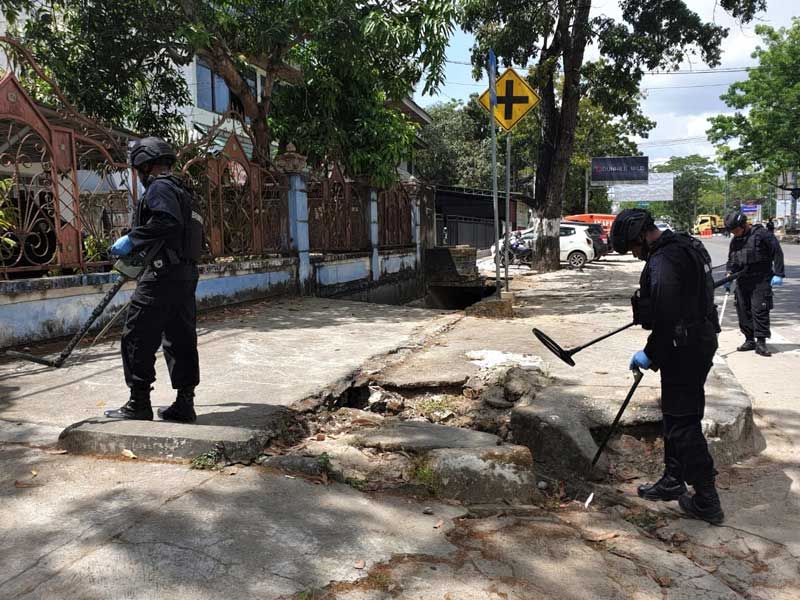  Personel Brimob mencari selongsong peluru saat olah tempat kejadian perkara di Jalan Abdullah Silondae, Kendari, Sulawesi Tenggara, kemarin