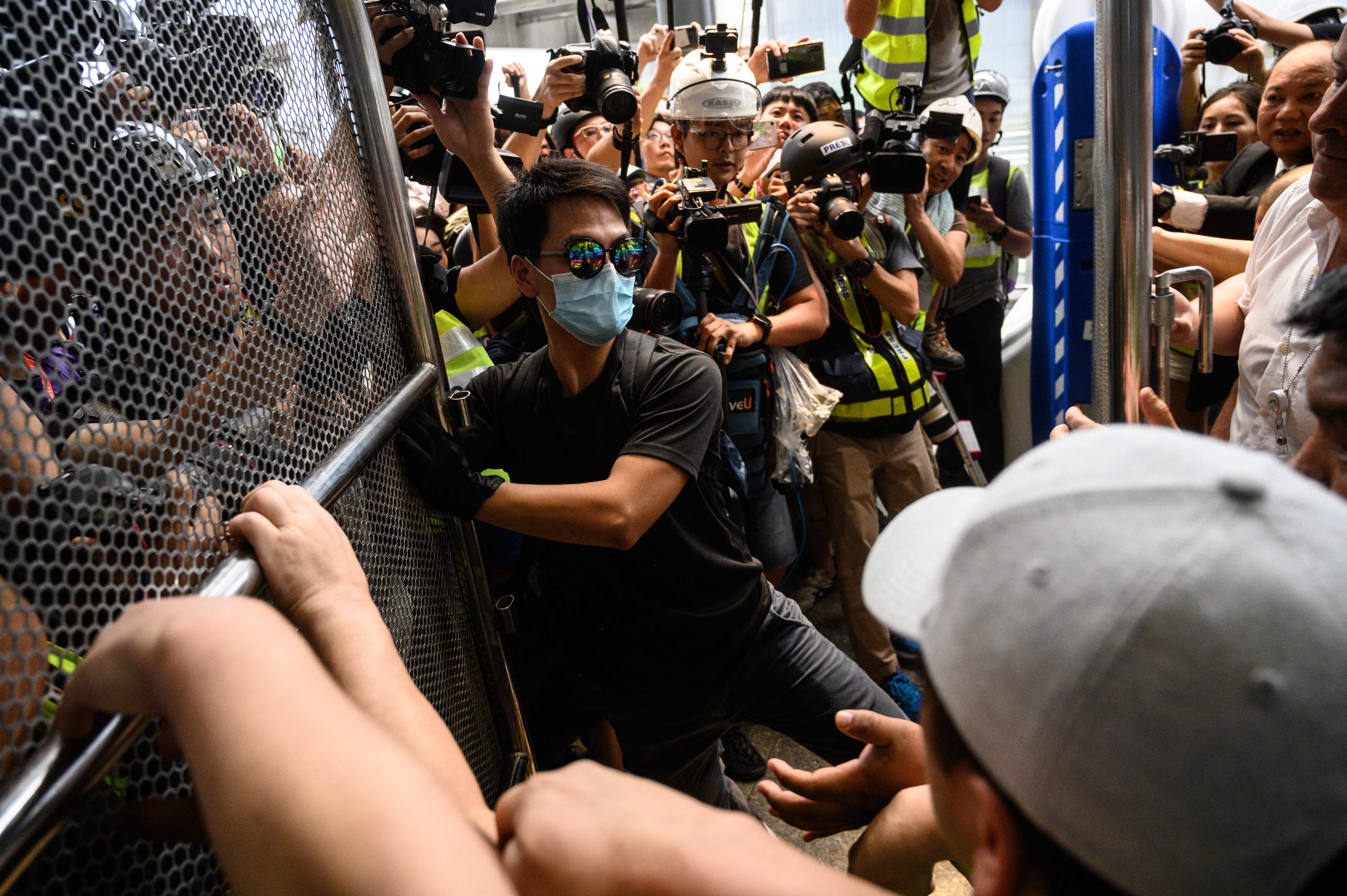 Seorang pengunjuk rasa mencoba memasuki Bandara Internasional Hong Kong pada Minggu (1/9). 