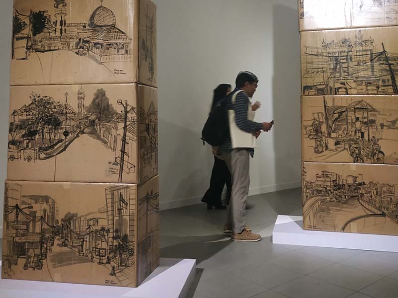 Sketsa berjudul Seputaran Kebayoran karya KaNa. Sketsa ini dibuat dengan tina cina di atas media kardus.