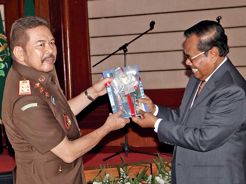 Jaksa Agung periode 2014-2019 HM Prasetyo memberikan buku Bakti Adhyaksa kepada Jaksa Agung yang baru, ST Burhanuddin (kiri).