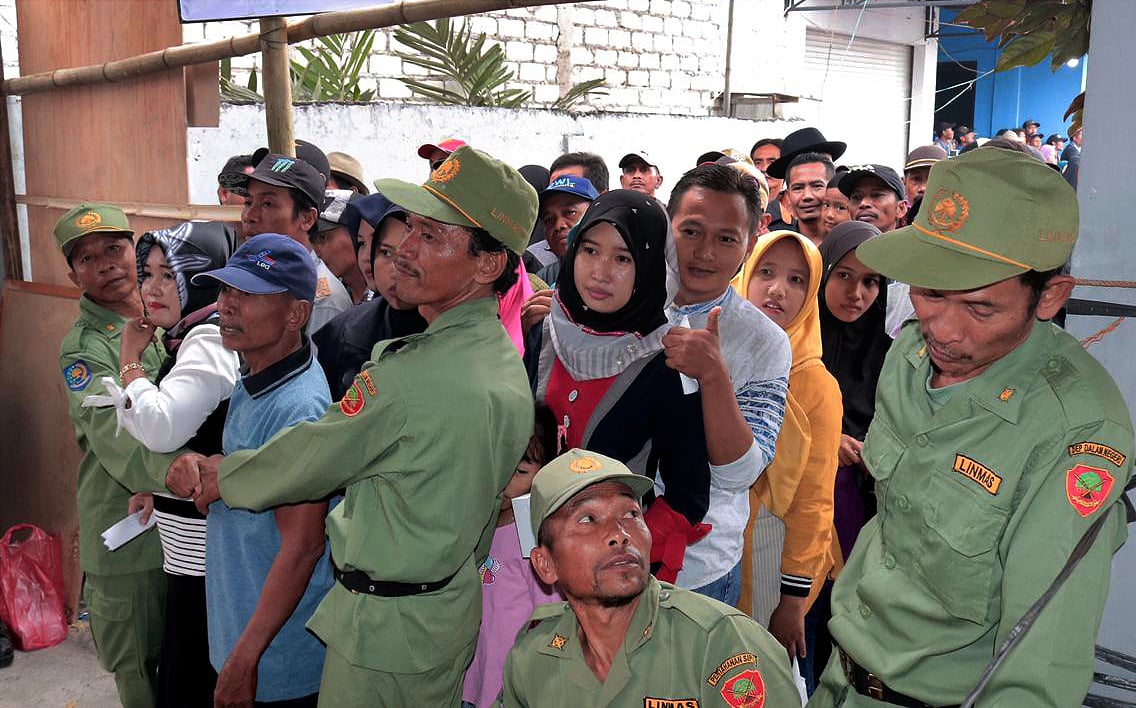 Antrean warga yang akan menggunakan hak pilihnya pada pelaksanaan pemilihan kepala desa (pilkades) serentak di Desa Sedayulawas, Lamongan