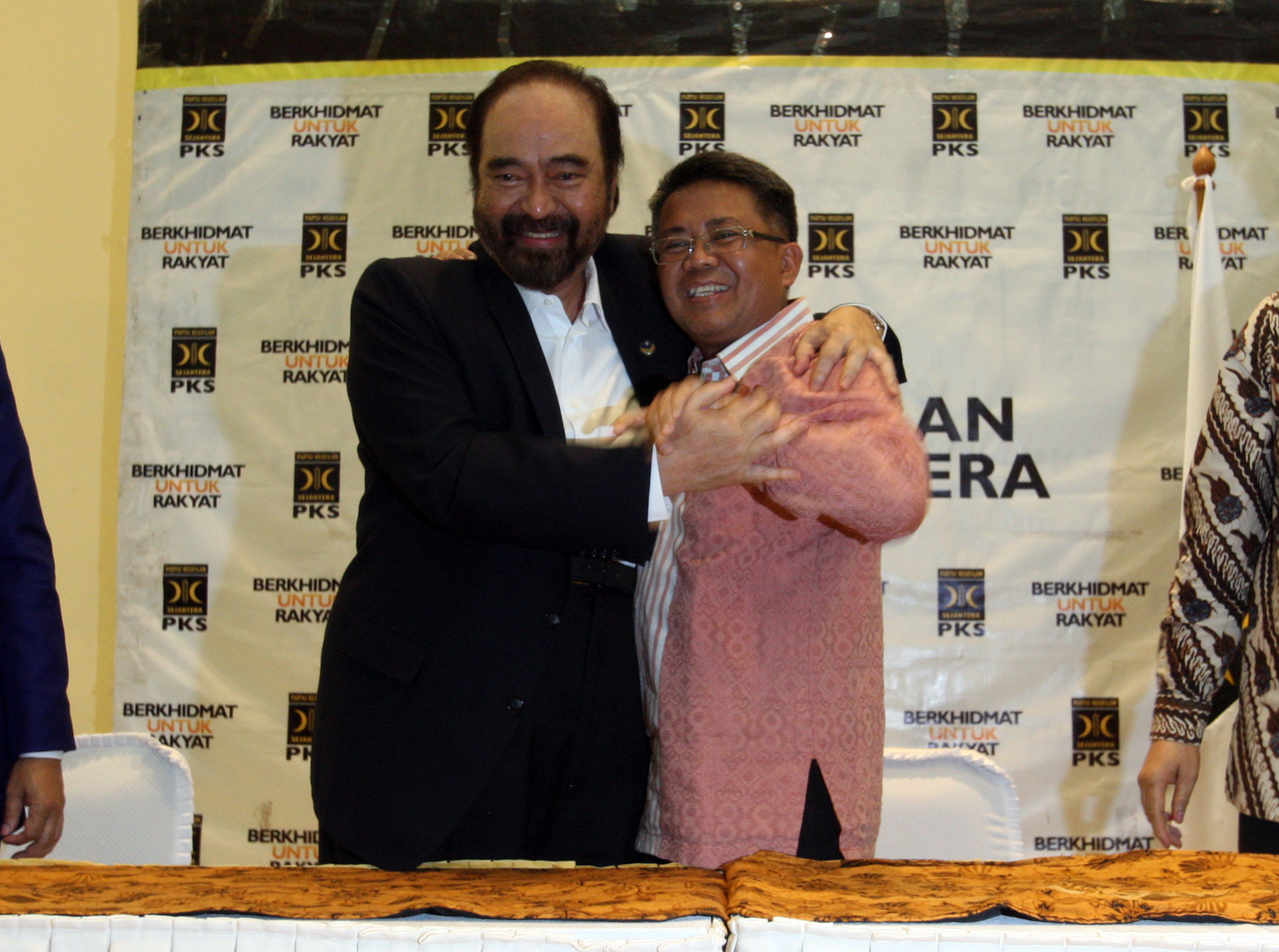 Ketua Umum Partai Nasional Demokrat (NasDem) Surya Paloh (kiri) berpelukan dengan Presiden Partai Keadilan Sejahtera (PKS) Sohibul Iman