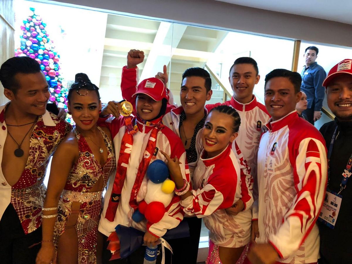 Dwi Cindy Desyana (tengah) merayakan keberhasilan meraih emas dancesport di ajang SEA Games 2019 di Clark, Filipina, 