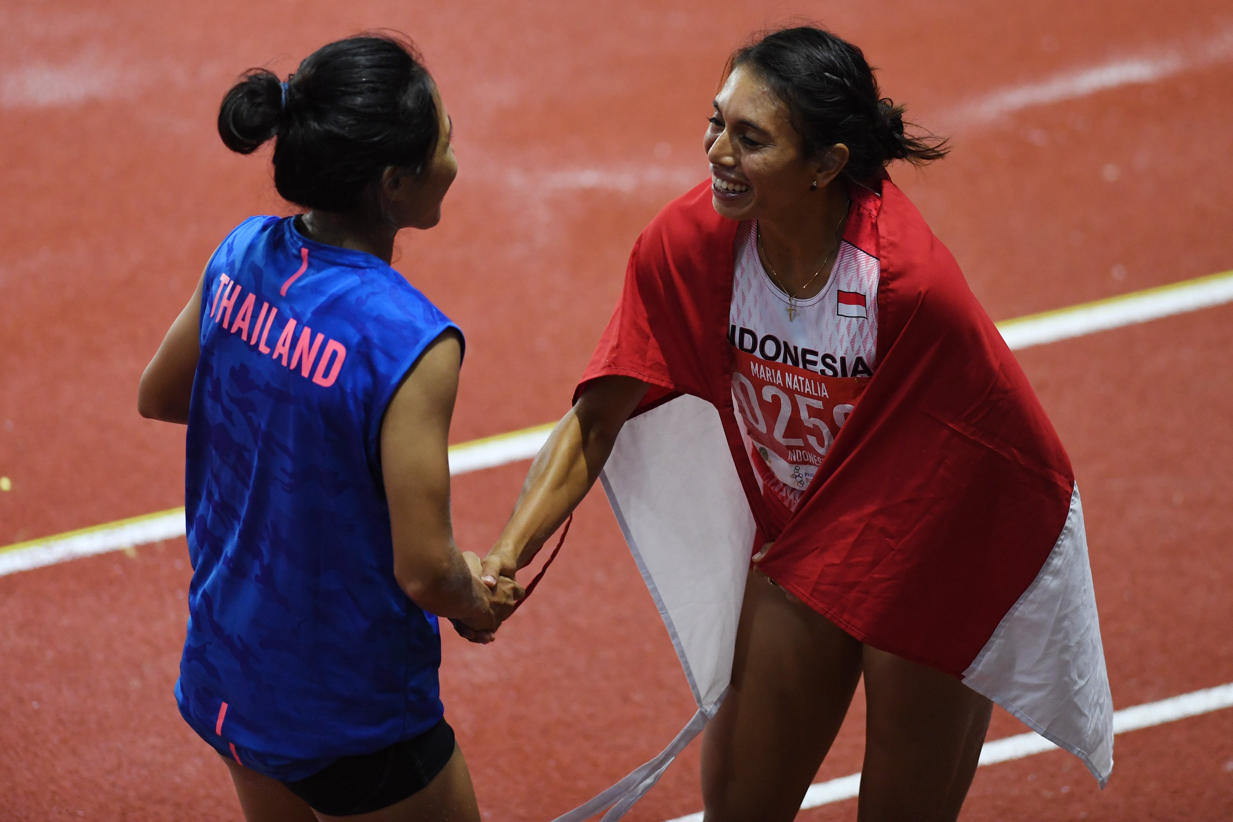 Atlet lompat jauh Indonesia Maria Natalia Londa bersalaman dengan atlet Thailand Parinya Chuaimaroeng.