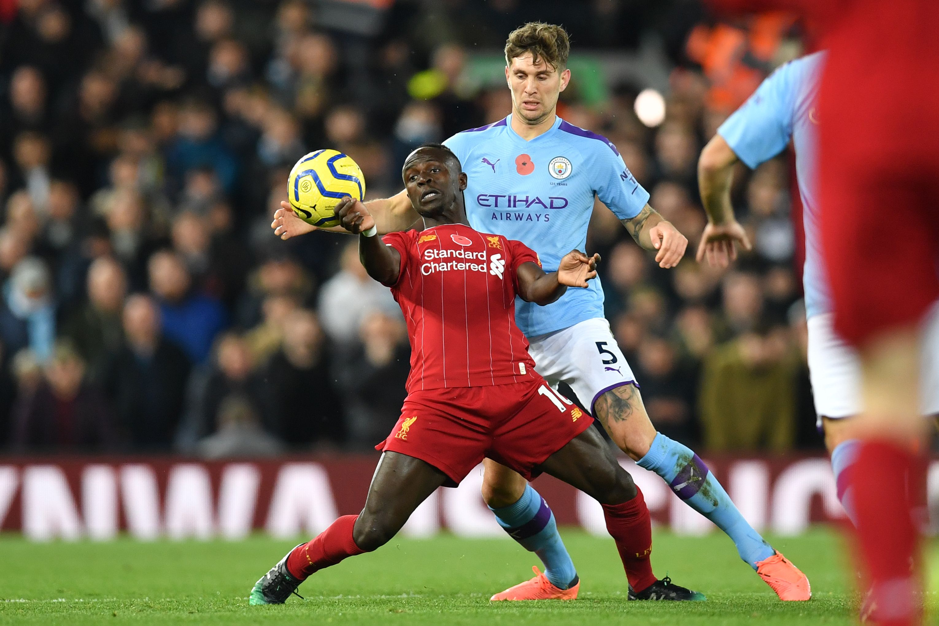 Striker Liverpool Sadio Mane (depan) bersama bek Manchester City John Stones (belakang)