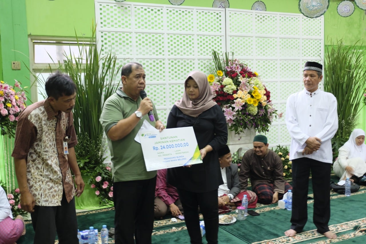  Kepala Kantor Cabang BP Jamsostek Jakarta Slipi,Tidar Yanto Haroen, menyerahkan santunan kepada ahli waris almarhum Lasmi.  