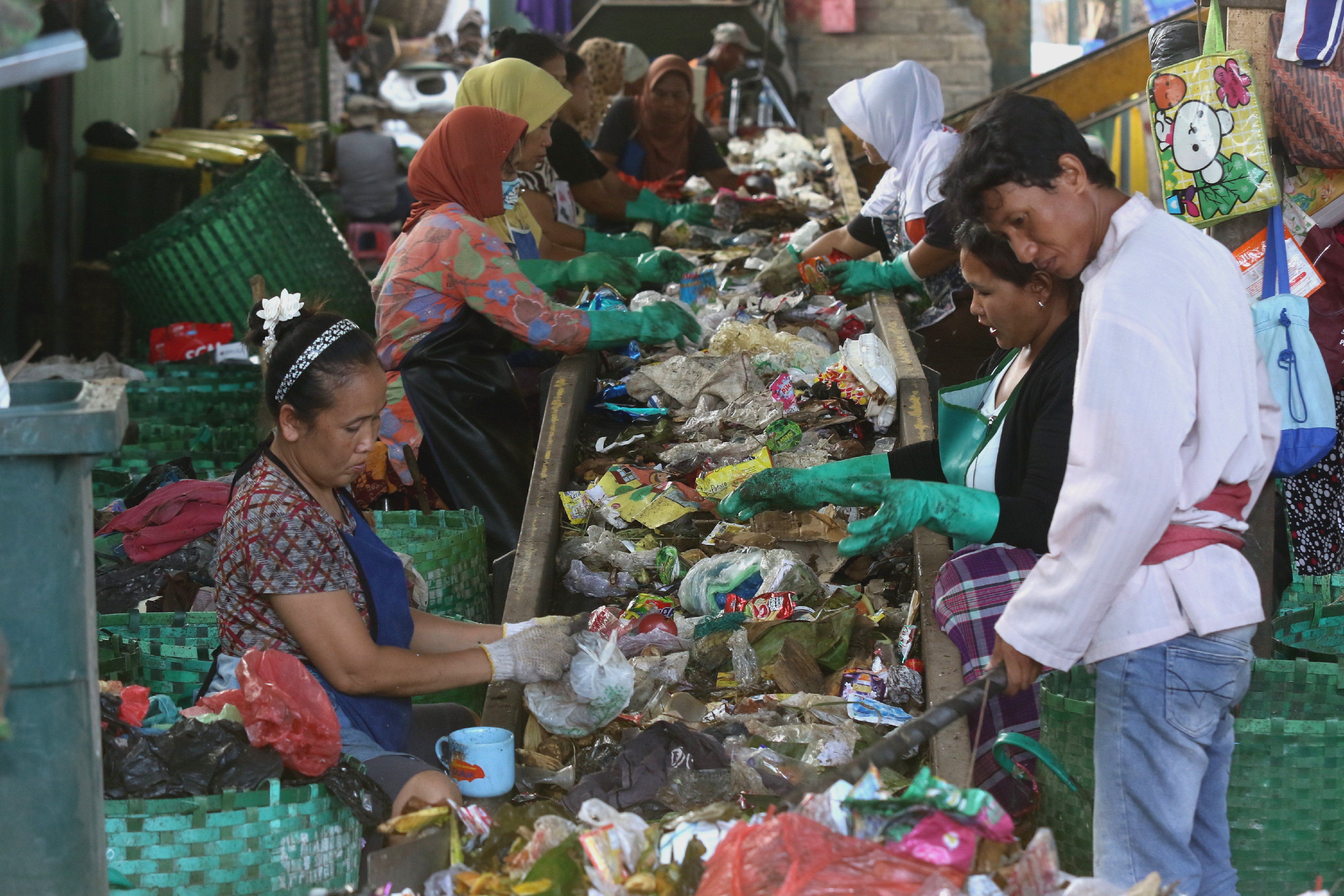 Pekerja memilah sampah hasil pengumpulan dari warga di Pengolahan Sampah, Tembok Rejo, Muncar, Banyuwangi, Jawa Timur
