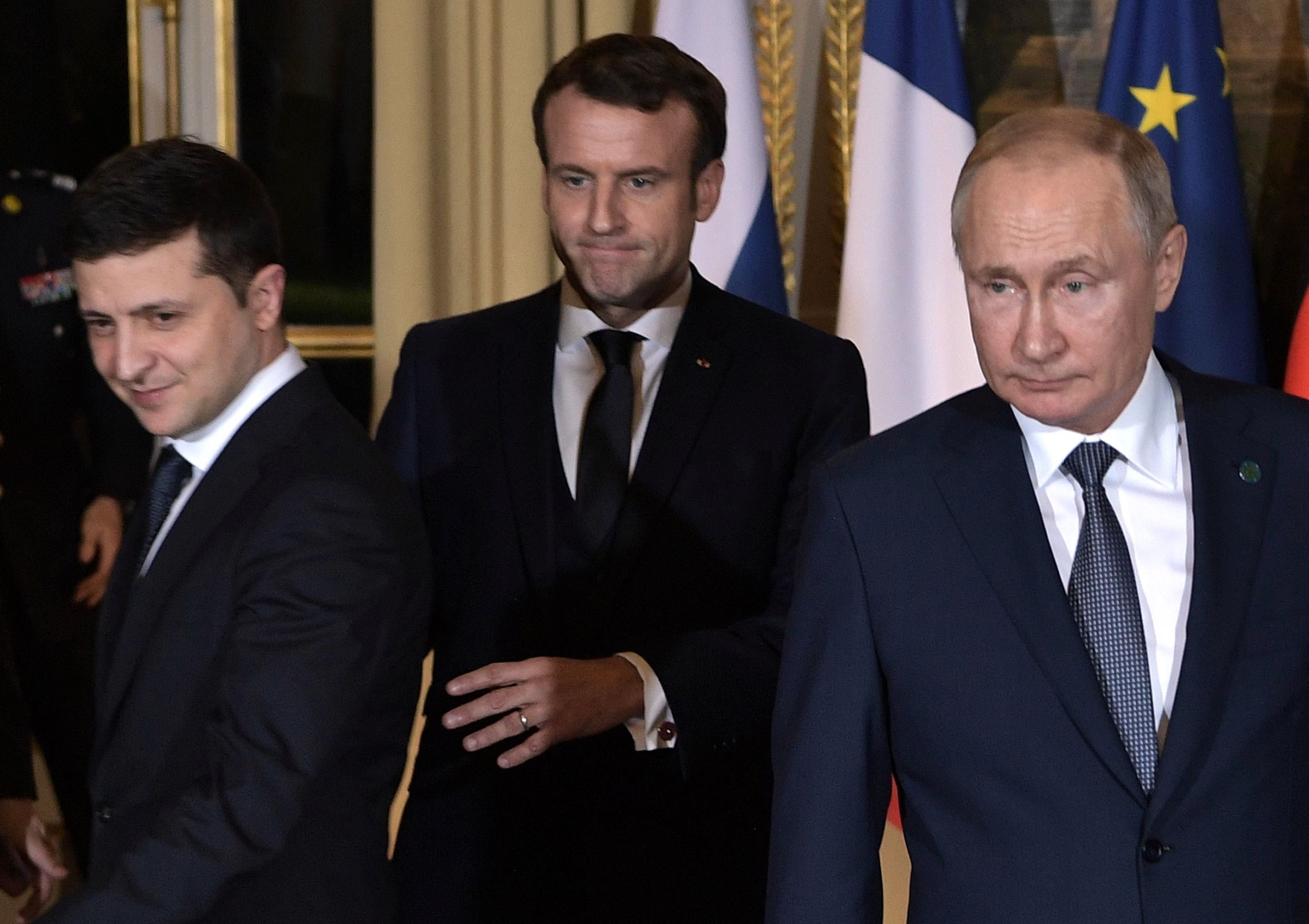 Presiden Ukraina Volodymyr Zelensky (kiri) dan Presiden Rusia Vladimir Putin (kanan) mengapit Presiden Prancis Emmanuel Macron