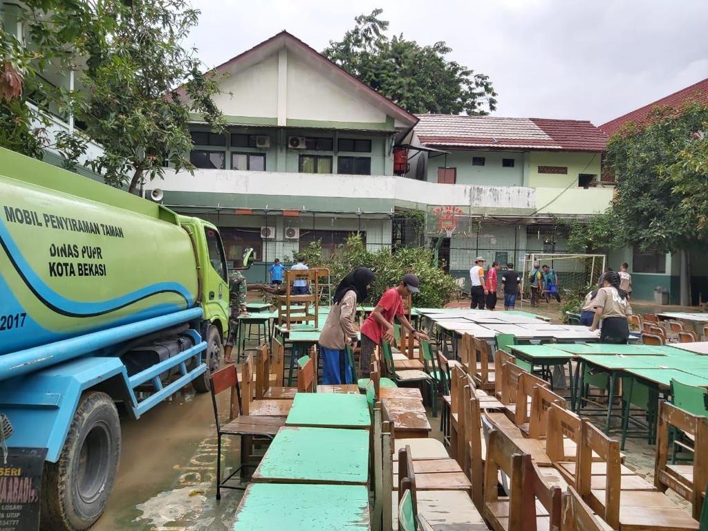 Aparatur Pemerintah Kota Bekasi membantu pembersihan lingkungan sekolah SMA Negeri 6 Kota Bekasi. 
