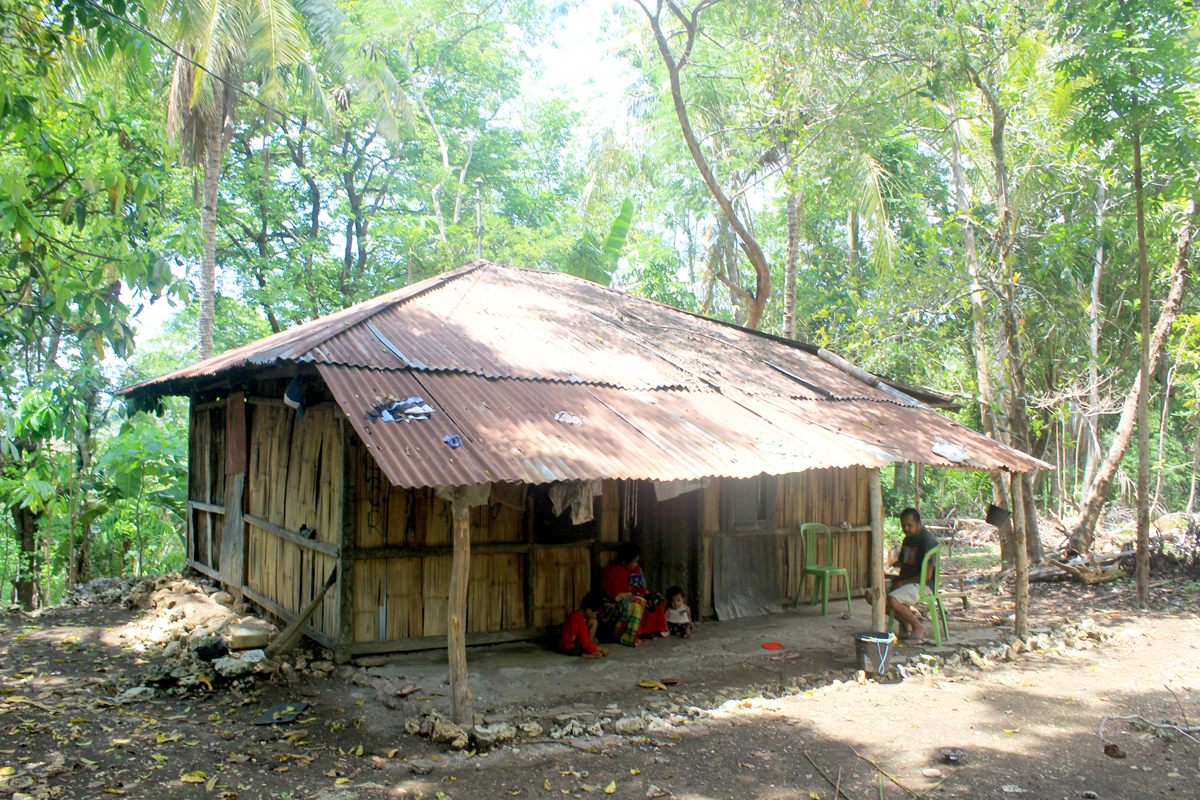 Erni Lakusaba, 42, bersama dua anaknya, Diana (kanan) dan Marsanu (kiri) di rumah mereka Kelurahan Oenesu, Kecamatan Kupang Barat, NTT.