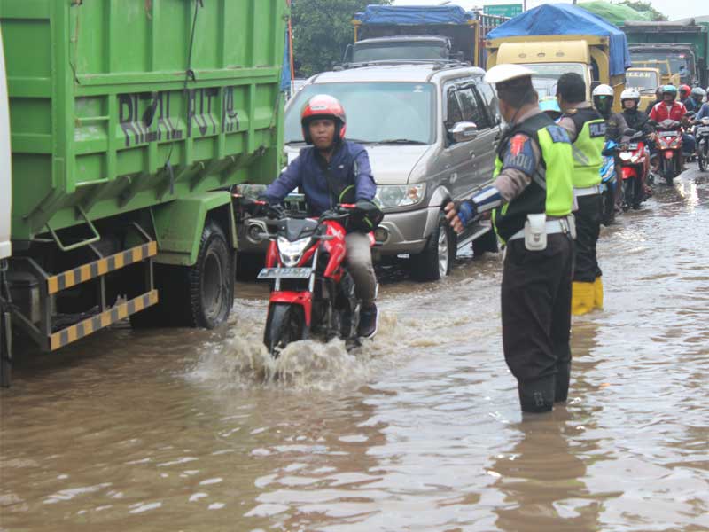 Personil Satlantas Polres Pasuruan Kota, Jawa Timur, sedang mengatur arus lalu lintas di jalan raya pantai utara (Pantura).