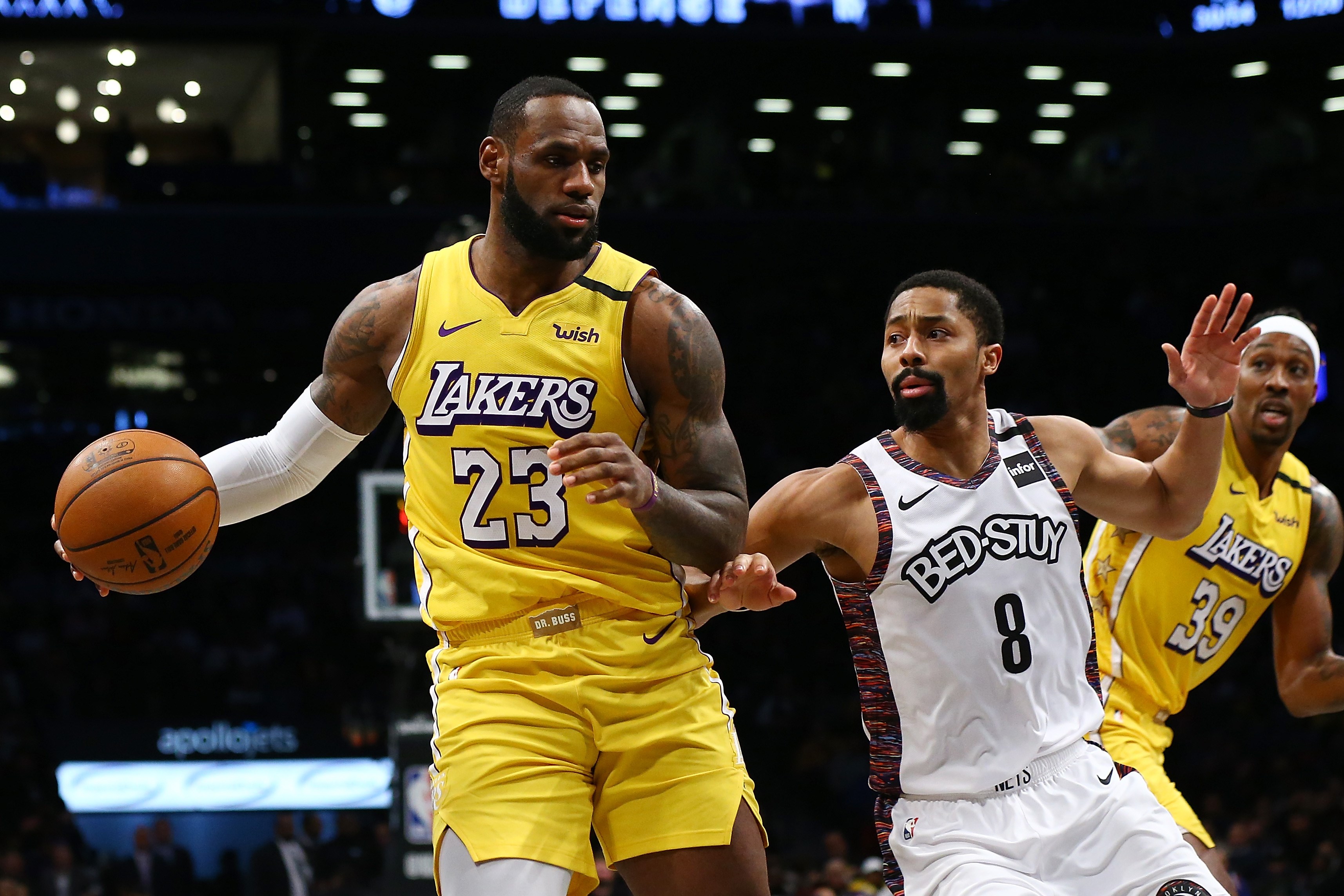 Aksi LeBron James (kiri) dari LA Lakers dan Spencer Dinwiddie (tengah) dari Brooklyn Nets. Kini, para pemain Lakers telah berlatih lagi.